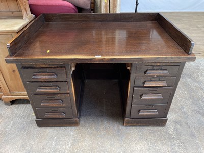 Lot 141 - 1920s oak twin pedestal desk with an arrangement of drawers