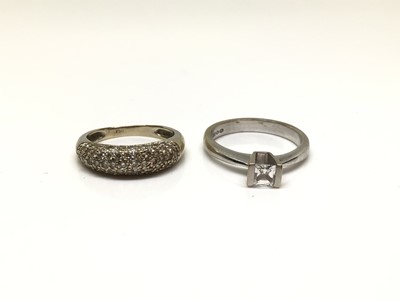 Lot 194 - 18ct white gold diamond set band ring and 18ct white gold solitaire ring set with a synthetic white stone (2)