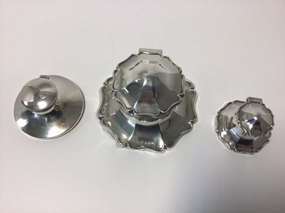 Lot 23 - Three sterling silver inkwells,the largest with scalloped edge, 12.5cm diameter, Birmingham 1919, another of similar shape and 6.5cm diameter, also Birmingham 1919, and a third of plain round form,...