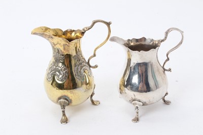 Lot 465 - George II silver helmet shaped cream jug and a Victorian silver cream jug.