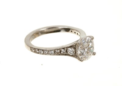 Lot 636 - Diamond single stone ring with a round brilliant cut diamond weighing 1.51cts in platinum four claw setting with graduated diamond set shoulders on platinum shank. Accompanied by a Diamond Report b...