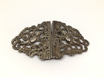 Lot 198 - Silver nurse’s buckle with embossed foliate and Cupid decoration