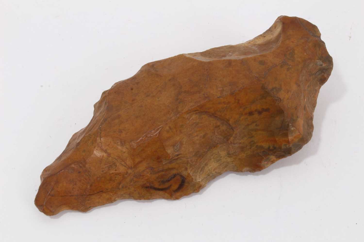 Lot 951 - Palaeolithic stone axe or knife, rich pumpkin orange patination colour, probably lower Palaeolithic culture, Acheulian, c.400,000 - 200,000 BC. Provenance: The late Edwin Rufus Walpole Eyre Collect...