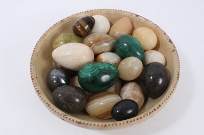 Lot 872 - Collection of specimen polished eggs, including malachite, jasper, onyx, alabaster and others. In a 19th or early 20th century glazed pottery bowl