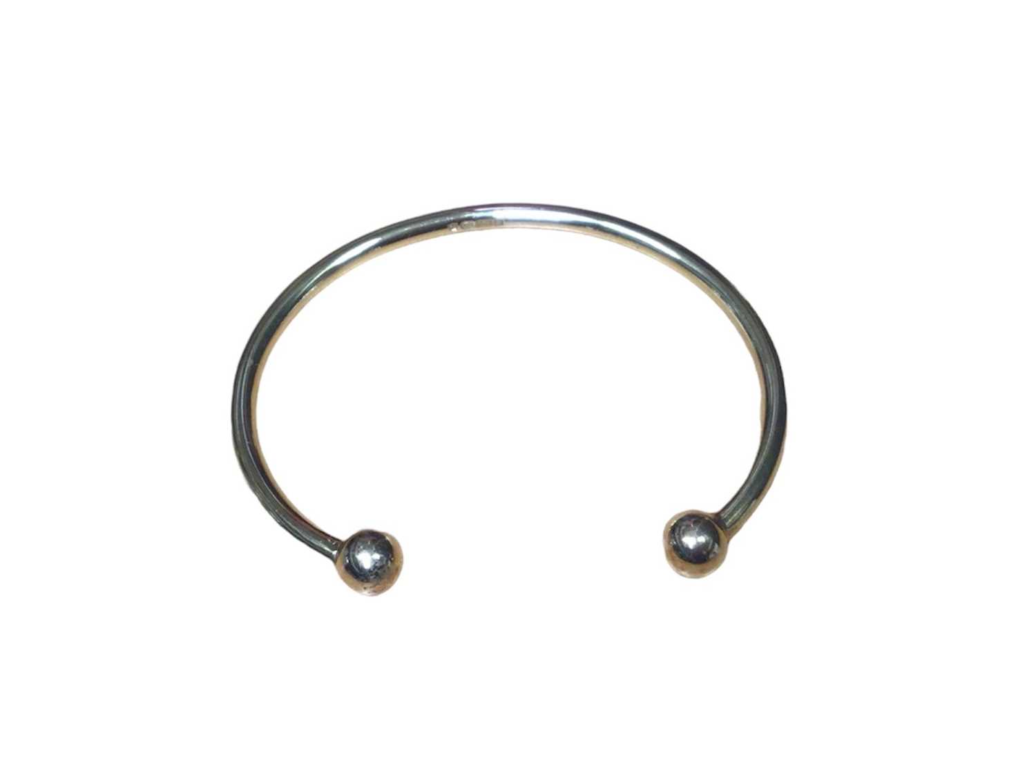 Lot 19 - 9ct gold torque bangle with ball terminals