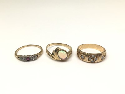 Lot 1011 - Three 14ct gold rings to include a diamond and ruby ring, opal single stone ring and one other ring set with six opal cabochons