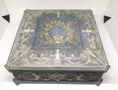 Lot 1005 - American Incolay blue stone jewellery box with relief putti and foliate scroll decoration. 24cm x 24xm x 9cm