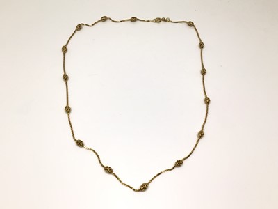 Lot 1014 - 9ct gold chain interspaced with oval gold beads, 46cm long