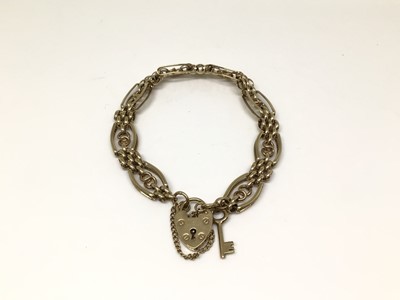 Lot 1018 - 9ct gold gate bracelet with key charm and padlock clasp