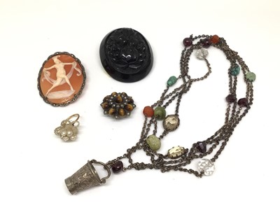 Lot 1022 - Long chain interspaced with various beads and a silver bucket pendant, together with a cameo brooch, tiger's eye and seed pearl flower head brooch, carved jet brooch and one pearl cluster earring