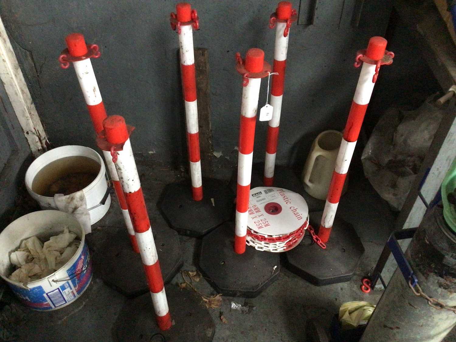 Lot 19 - Six red and white weighted base posts and plastic chain