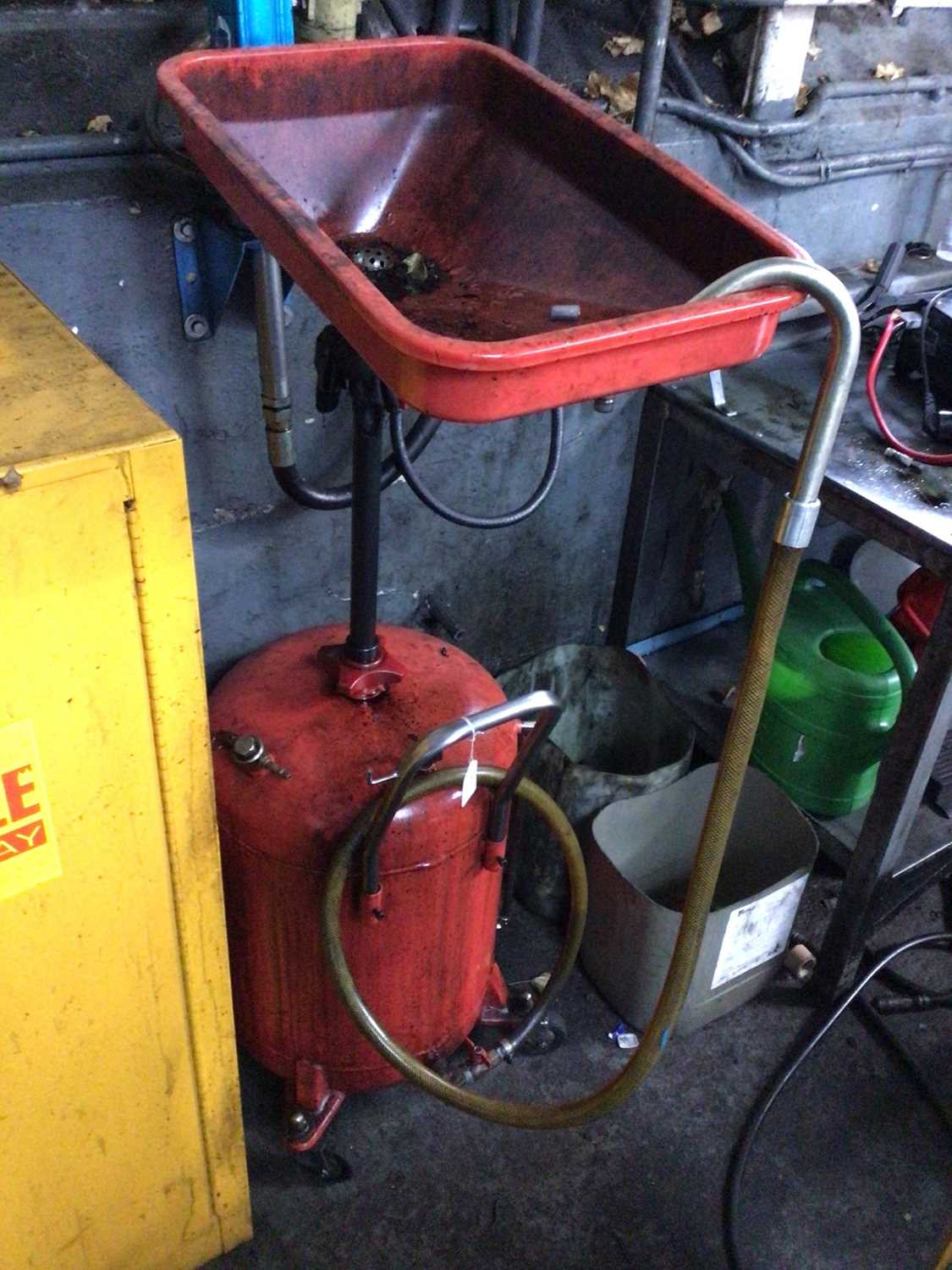 Lot 62 - Portable oil draining system with red bottle