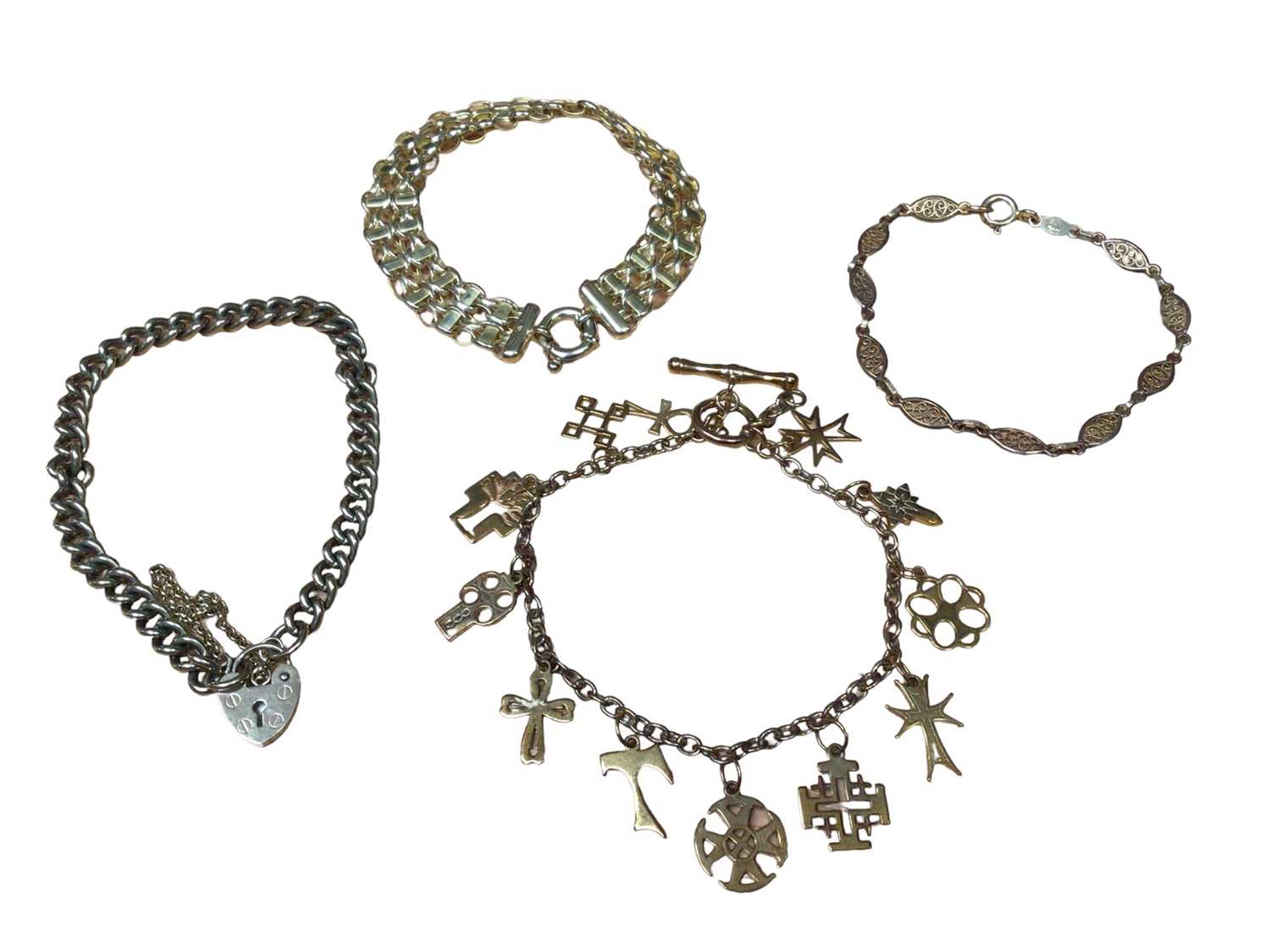 Lot 180 - 9ct gold charm bracelet, 9ct gold curb link bracelet with padlock clasp and two other 9ct gold bracelets (4)