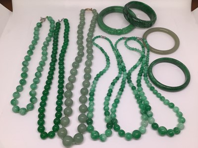 Lot 1025 - Six contemporary green hard stone polished bead necklaces and four green hard stone bangles