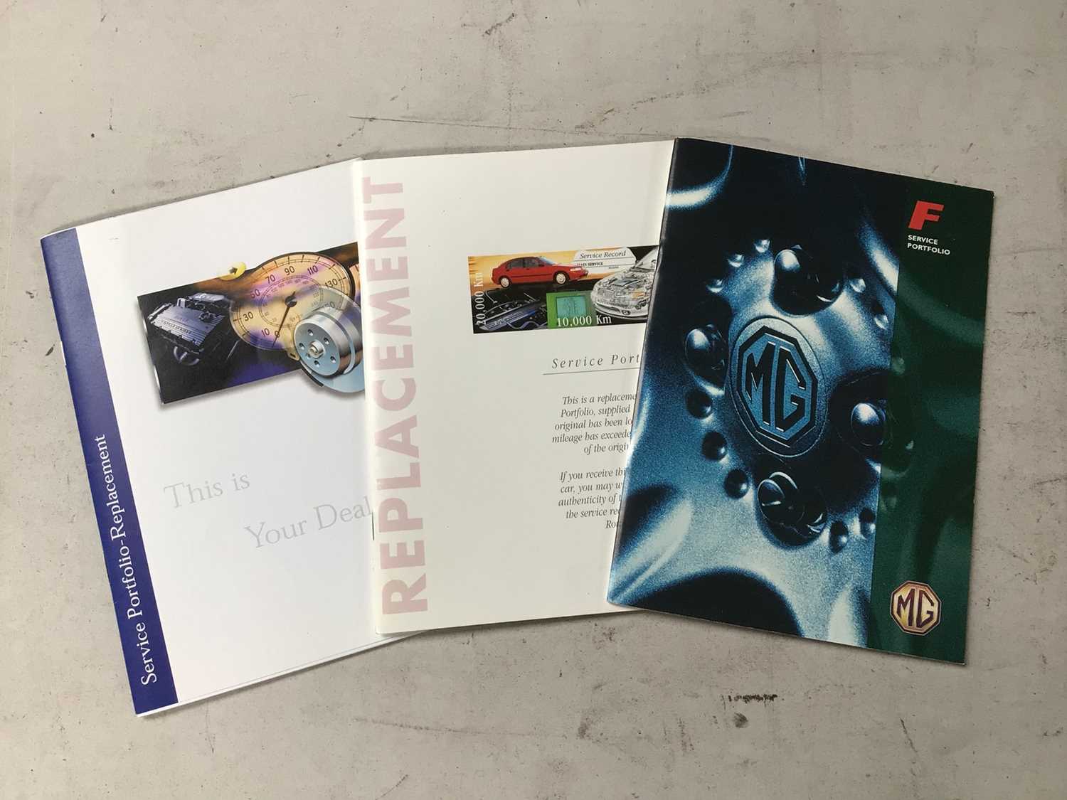 Lot 113 - MGF unused Service Book & Replacement Service Books (3)