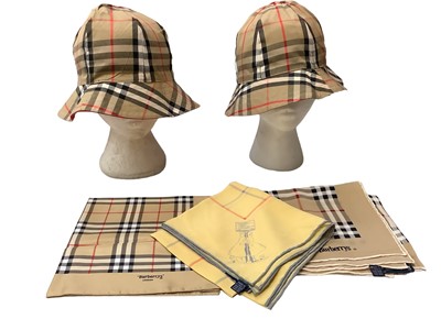 Lot 2137 - Three vintage Burberry silk scarves and two Gentlemen's ties, plus two reversible bucket hats (with no labels).