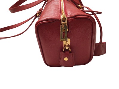 Lot 2127 - Prada saffiano red leather Bowling bag with padlock and key.  Dimensions W.28cm, H. 15cm (not including handles), D. 13cm, all approximate.