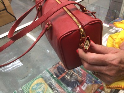 Lot 2127 - Prada saffiano red leather Bowling bag with padlock and key.  Dimensions W.28cm, H. 15cm (not including handles), D. 13cm, all approximate.