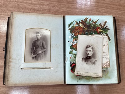 Lot 1598 - Two Victorian leather photograph albums containing various CDV and Cabinet card photographs including an amusing photograph of a man holding an African Grey Parrot.