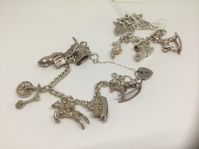 Lot 1084 - Two silver charm bracelets