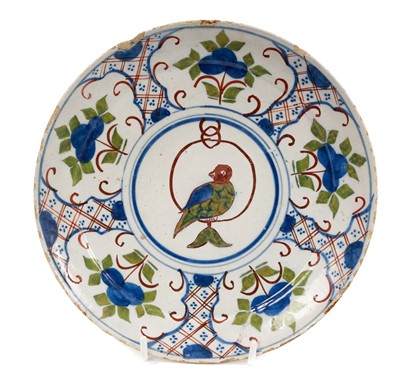 Lot 244 - Unusual Delft saucer dish, circa 1740, painted with a parrot