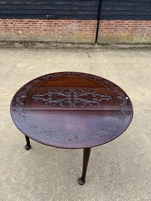 Lot 25 - George III mahogany oval gateleg dining table with carved decoration on pad feet