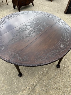 Lot 25 - George III mahogany oval gateleg dining table with carved decoration on pad feet