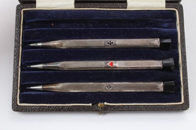 Lot 470 - Three silver matchbox covers and a set of three silver bridge pencils in fitted case