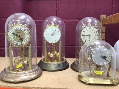 Lot 762 - Collection of twelve anniversary clocks with perpetual motion movements including some with glass domes (12)