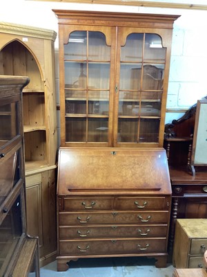 Lot 1209 - Georgian style burr walnut two height bureau bookcase, with two glazed doors, fitted writing compartment and five drawers below, 101.5cm wide, 47cm deep, 217cm high