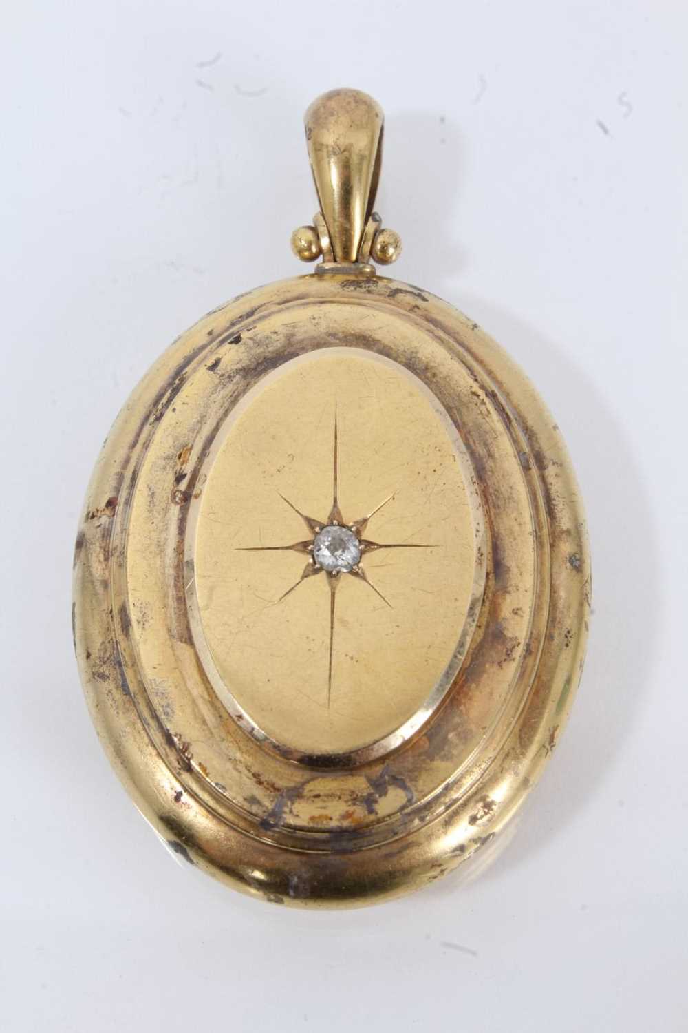 Lot 706 - Victorian yellow metal oval locket set with