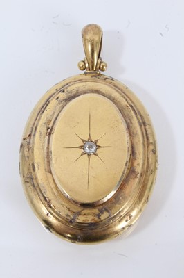 Lot 706 - Victorian yellow metal oval locket set with a single stone old cut diamond