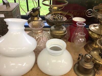 Lot 58 - Collection of brass oil lamps and glass shades, a model ship, etc