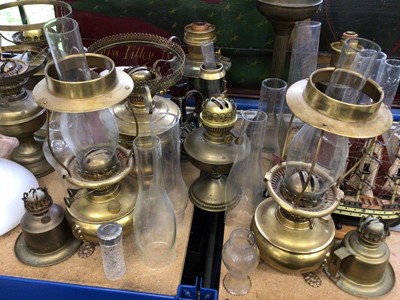 Lot 58 - Collection of brass oil lamps and glass shades, a model ship, etc