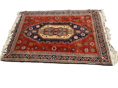 Lot 1303 - Persian design rug on red ground