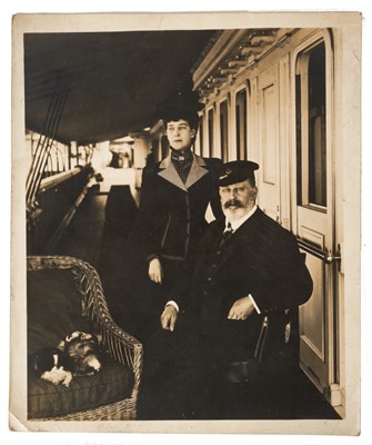 Lot 36 - T.R.H. King Edward VII and Queen Alexandra, fine portrait photograph of the relaxed Royal couple with dog on board the Royal Yacht Victoria & Albert 30.5 x 25.5 cm Provenance: the Russell & Sons Co...