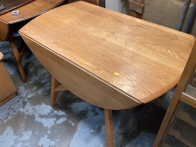 Lot 1293 - Ercol drop leaf dining table on splayed legs joined by X frame stretchers, opening to 113cm x 123cm, together with a pair of Ercol dining chairs (3)