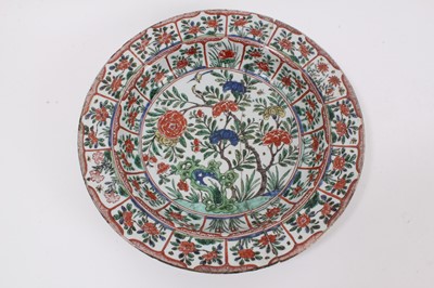 Lot 225 - A Chinese famille verte dish, Kangxi period, decorated with birds and flowers, the outside panelled, double-ring mark to base, 34.5cm diameter