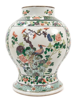 Lot 226 - A large 19th century Chinese famille verte baluster vase, decorated with two panels, on one side with birds and flowers, the other with precious objects and auspicious symbols, on a floral patterne...