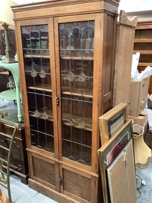 Lot 1303 - Edwardian oak bookcase with shelved interior enclosed by two tinted and leaded glazed doors, with two panelled doors below, 91cm wide, 30cm deep, 198cm high