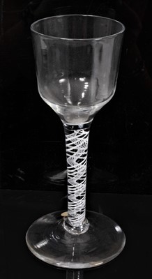 Lot 230 - A Georgian double-series opaque twist wine glass, circa 1760, with ogee bowl, the stem consisting of a three-ply spiral band outside a spiral gauze, on a conical foot, 17.5cm high