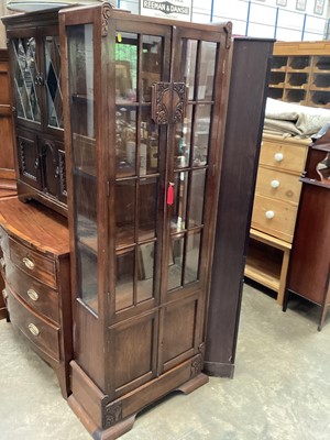 Lot 1315 - 1930's carved oak bookcase with shelved interior enclosed by two glazed doors with two further panelled doors below, 71cm wide, 33.5cm deep, 184cm high