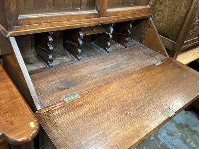 Lot 1319 - Edwardian oak two height bureau bookcase with shelves above enclosed by two glazed doors, writing slope, two drawers and two panelled doors below, 108cm wide, 45cm deep, 213cm high