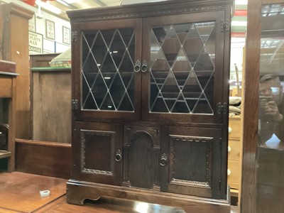 Lot 1332 - Oak bookcase with adjustable shelf enclosed by two leaded glazed doors, with two panelled doors below, 83cm wide, 25cm deep, 103cm high