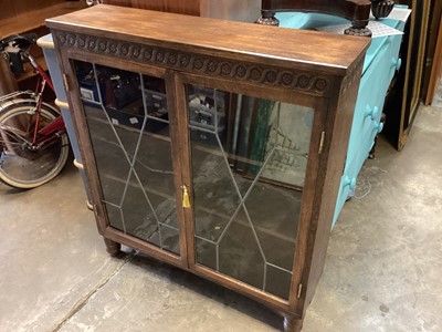 Lot 1334 - Oak bookcase with carved decoration and shelved interior enclosed by two leaded glazed doors, 99.5cm wide, 26cm deep, 108.5cm high