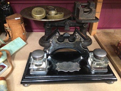 Lot 708 - Decorative desk ink well stand, set of scales, two wooden mantle clocks, canteen of cutlery and sundries