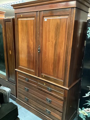 Lot 1345 - Victorian mahogany linen press with four slides enclosed by two panelled doors, two short and two long drawers below, 132cm wide, 54.5cm deep, 210cm high