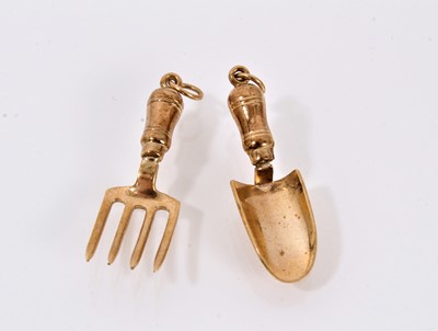 Lot 747 - Two gold charms in the form of a trowel and fork