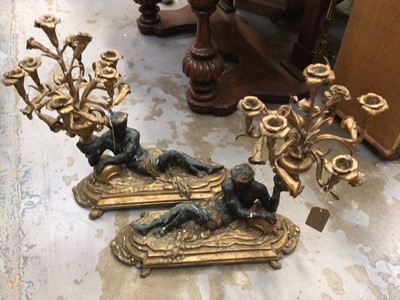 Lot 722 - Pair of cast metal candelabra with reclining man on decorative plinth bases, 60 cm high x 55 cm long