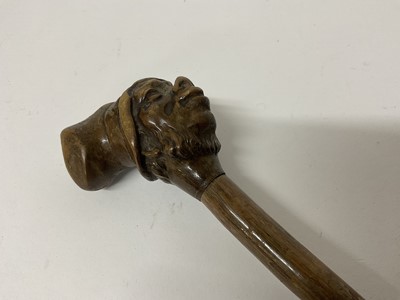 Lot 283 - 19th century novelty carved wooden walking stick with stylised head knop, 79cm long